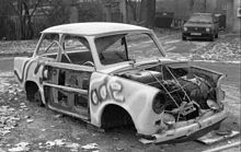 Many Trabant vehicles were abandoned in Germany after 1989 (this one photographed in Leipzig, 1990). A Volkswagen Golf can be seen parked in the background. Private brands like Volkswagen spilled over into East Germany after its state-owned auto industry collapsed. Bundesarchiv B 145 Bild-F086568-0046, Leipzig, ausgeschlachteter PKW Trabant (Trabbi).jpg