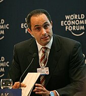 Man talking into a microphone at the World Economic Forum