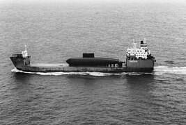 A Chinese Kilo-class submarine being delivered from Russia as deck cargo in 1995.