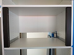 The cabinet frame with a reinforced shelf and and two black Nyttig support brackets; notice the cut-out in the cabinet's backside. It's for the electrical connections.