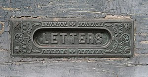 New Orleans: Brass letter slot in old door, Al...