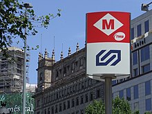 TMB (top) and FGC (bottom, old) logos outside Placa de Catalunya station. Metro i FGC Placa Catalunya Barcelona.jpg