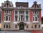 A three storey building symmetrically composed with fully developed detail. The ornate entrance gates and the interior carpentry are of particular note. The building was declared a national monument in 1978. The striking Harbour Board building, also known as the White House, is situated in Fleming Street, near the harbour and the railway station in the immediate vicinity of the Port Elizabeth city hall. The corner stone of this building, for nearly seventy ye[clarification needed] Architectural style: Edwardian Baroque with Art Nouveau interior. This building is proclaimed on account of its outstanding architecture, it was built in 1904, and is an excellent example of the so-called Art Nouveau in architecture.