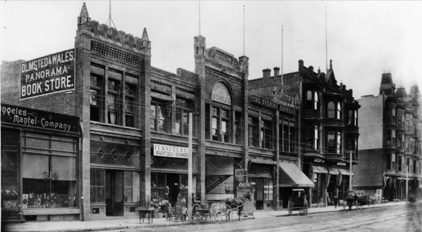 Panorama Building, E side of Main between Mayo (3rd) and 4th, c. 1890. The center entrance led through to the panorama exhibition space in the back. Note the Olmsted & Wales Panorama Bookstore, and the offices of the Evening Express. At right, the Hotel Westminster at the NE corner of 4th/Main.