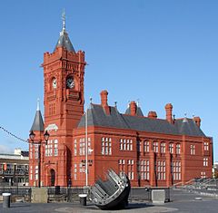 Red brick building with large central clock tower