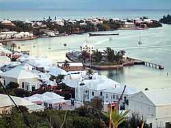 St. George's town (originally named New London), in the Islands of Bermuda, or "The Somers Isles". The colony was founded by the wrecking of the flagship of the Virginia Company in 1609. The company's charter was extended to include Bermuda in 1612, and it has remained an English (since 1707, British) colony ever since. Since the rebellion of Virginia, it has been the oldest-remaining British colony, and the town of St. George's is the oldest continuously inhabited British settlement in the New World. Bermuda-Harbour and Town of St George.jpg