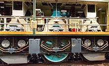 The motor room of a 2D2 5500 with the body side removed, showing the traction motor above each axle with a reduction gear down to the flexible Buchli drive