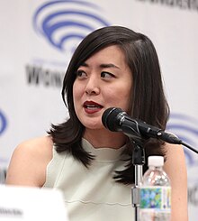 Fu seated at table during panel discussion at WonderCon 2023