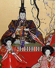 An Emperor doll, with two handmaidens.
