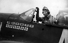 James Howard sitting in the cockpit of his P-51 Mustang fighter plane