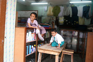 English: The kids in their mother store in Zan...