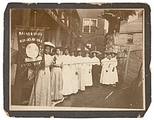 Nannie Helen Burroughs holding a Woman's National Baptist Convention banner Nannie Burroughs, Woman's National Baptist Convention.jpg