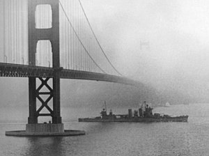 USS San Francisco (CA-38) steams under the Golden Gate Bridge on 11 December 1942 (80-G-40093).jpg