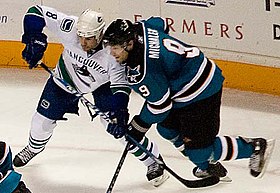 Mitchell (left) battles for position with Milan Michalek of the San Jose Sharks during a December 2007 game. Willie Mitchell and Milan Michalek.jpg