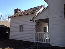 A one and one-half-story white wooden building