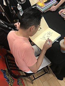 Cliff Chiang, who drew the New 52 version of the Wonder Woman series, sketching the character in a fan's copy of one of the Absolute editions collecting that work, at a signing at Midtown Comics in Manhattan 8.1.19CliffChiangByLuigiNovi7.jpg