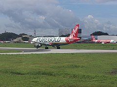 Air Asia Puregold plane at NAIA runway