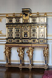 Baroque caryatids of a cabinet; c.1675; ebony, kingwood, marquetry of hard stones, gilt bronze, pewter, glass, tinted mirror and horn; unknown dimensions; Museum of Decorative Art, Strasbourg, France[124]