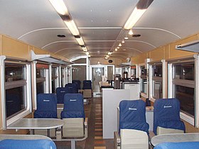 Салон промежуточного вагона дизель-поезда ДР1А-230 с сиденьями 1 класса с откидными сидушками и баром