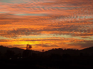A colourful sky is often due to scattering of light off particulates and pollution, as in this photograph of a sunset during the October 2007 California wildfires. Firesunset2edit.jpg