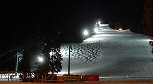 A trail lighted at night for night skiing