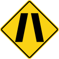 Road narrows on both sides