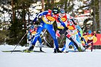 Multiple skiers in the middle of cross country skiing race.