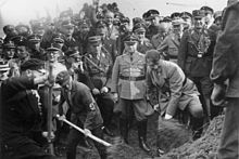 Hitler at a groundbreaking ceremony for a new section of the Reichsautobahn highway system, in 1933 Bundesarchiv Bild 183-R27373, Reichsautobahn, Adolf Hitler beim 1. Spatenstich, bei Frankfurt.jpg