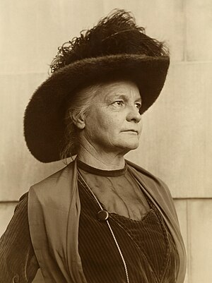 Sepia-toned picture of Elizabeth Glendower Evans wearing a large feathered hat