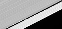 Waves in the Keeler gap edges induced by the orbital motion of Daphnis (see also a stretched closeup view in the gallery). PIA08319 Daphnis in Keeler Gap.jpg