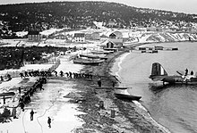 Pulling a Royal Canadian Air Force Douglas B-18 Bolo out of Newfoundland waters, 1940. Newfoundland was occupied by Canadian forces during the war. Pulling the Digby from the sea.jpg