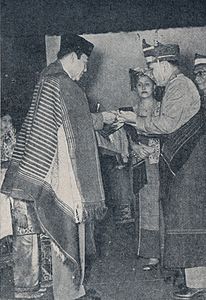 Sukarno receiving adat honor