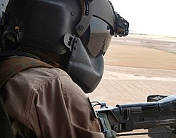 Sgt. Rikki Sanchez, from the 150th General Support Aviation Battalion, 42nd Infantry Division, mans an M60D machine gun during a UH-60 Blackhawk mission in northern Iraq. UH60doorgunner2005.jpg