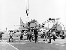 Black and white photo of an aircraft on the deck of an aircraft carrier