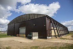 An aircraft hangar with support buttresses along its length