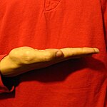 The "FlatB" handshape produced with the the thumb-side edge of the palm facing the camera