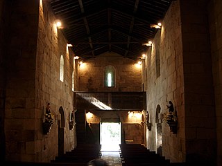 Interior of the Church of São Pedro de Rubiães seen towards the main entrance, with its wooden roof.