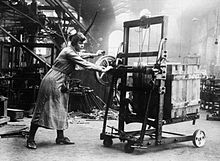 A female worker demonstrates a machine which can lift boxes to save physical labour at the Bowling Iron Works, Bradford, in November 1918