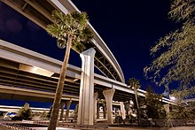 photo showing the multiple levels of roadways at the interchange between Interstates ten and seventeen, called "the stack" in downtown Phoenix at night.