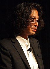 Portrait of Yoshio Sakamoto, making a public speech.
