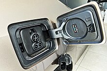 The i3 charging inlet is a CCS port above the rear wheel accepts AC and DC EVSE, localised to the region; this shows a Combo 1 port for North American vehicles. 2021 BMW i3 charging inlet port 03 2022 4742.jpg