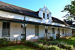 This Victorianised house, which was originally erected during the first half of the 19th century, together with seven similar structures, forms one of the most impressive street scenes in Stellenbosch.