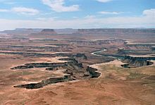 At Canyonlands National Park in Utah, sheets of water flow across the plains and enter the canyons. As they do so, the top edge of the canyon erodes back into the plain above, both lengthening and widening the canyon. Widening of a canyon by erosion inside the canyon below the top, because of the flow of the stream inside the canyon, is not called headward erosion. Canyonlands NP18.jpg