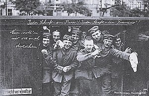 German soldiers on their way to war in August 1914. The words written on the car read "Every shot - a Russian! Every thrust - a Frenchman! Now we want to thrash them!" Some photographs such as this were staged for propaganda purposes. Erster Weltkrieg (Jeder Schuss - ein Russ'! Jeder Stoss - ein Franzos'!) OeNB 14672316 (1).jpg