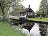 Kleine boerderij, behorend tot het grondtastype in de Giethoornse vorm van de hallehuisgroep. Woonhuis onder rieten zadeldak met puntgevel, voorzien van voorschot. Stal onder rieten schilddak met uileborden