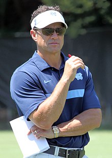 A color photograph of Larry Fedora in a golf shirt and visor