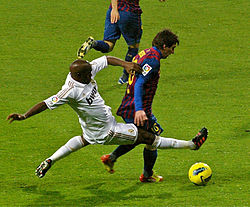 Real Madrid's Lassana Diarra tackling Barcelona's Lionel Messi during a 2011 Clásico.