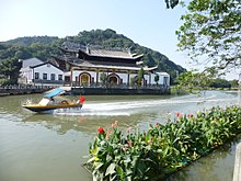 A temple of popular religion in Nanbaixiang, Ouhai, Wenzhou, Zhejiang. The facade of the left side building features the modern stylisation of the Lu 
lu / Zi 
zi symbol - . Nanbaixiang-Jiedao-canalside-P1200770.JPG