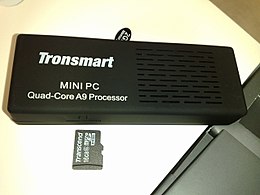 Tronsmart MK908, a Rockchip-based quad-core Android "mini PC", with a microSD card next to it for a size comparison Quad-core Android "mini PC", with a microSD card next to it for a size comparison.jpg