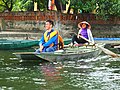 Woman rowing sampan with her feet in Ninh Bình Province of northern Vietnam